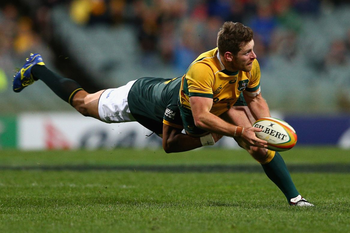 Australia's Bernard Foley is tackled by a South African player during a Rugby Championship match in Perth, Australia, on Saturday, September 6. Australia defeated South Africa 24-23.