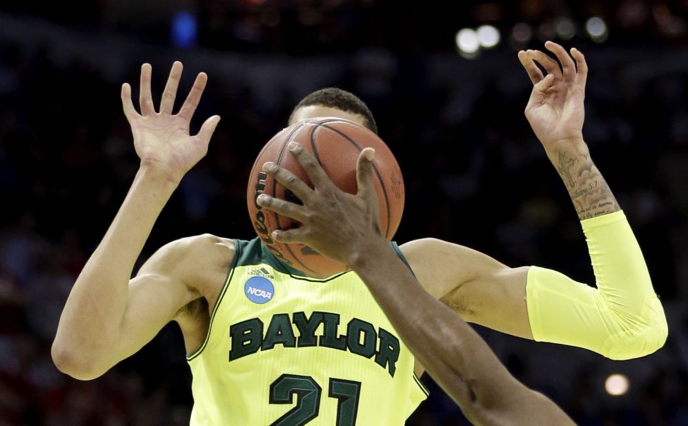 The face of Baylor's Isaiah Austin is covered by the basketball in this photo from the NCAA Tournament on Friday, March 21.