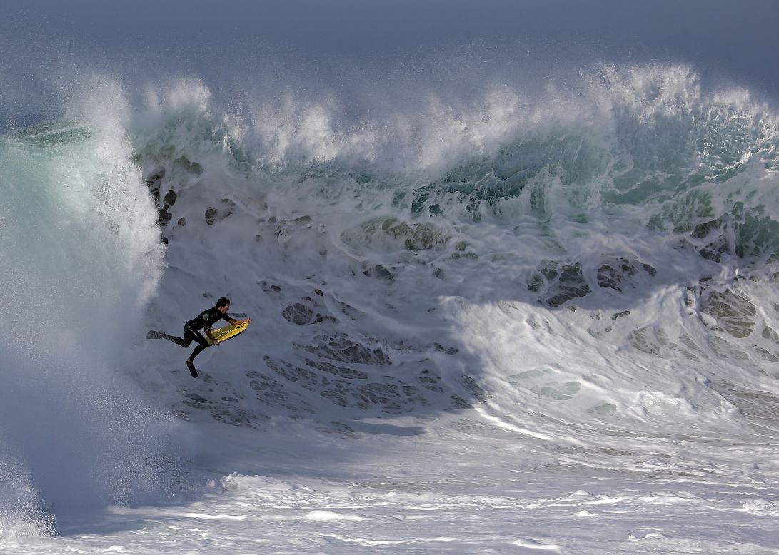 A bodyboarder rides a wave in Newport Beach, California, on Wednesday, August 27. Southern California beachgoers experienced higher than normal surf that was brought on by Hurricane Marie.