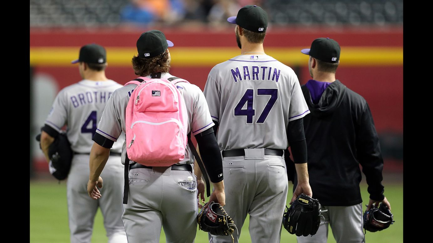Tommy Kahnle, a rookie pitcher with the Colorado Rockies, wears a pink backpack as he walks to the bullpen before a Major League Baseball game against the Arizona Diamondbacks on Wednesday, April 30.