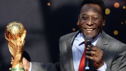 Brazilian football legend Pele looks at the FIFA World Cup trophy during the FIFA World Cup Trophy event on March 9, 2014.