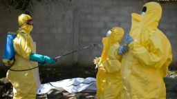 Guinean Red Cross workers prepare to carry the corpse of a victim of Ebola in Macenta on November 21, 2014. The World Health Organisation said that 5,420 people have so far died of Ebola across eight countries, out of a total 15,145 cases of infection, since late December 2013.