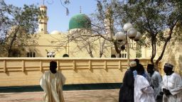 People discuss in front of the central mosque in the northern Nigerian city of Kano in January 2012.