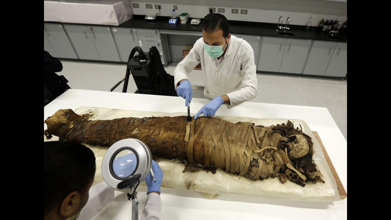 <strong>March 17:</strong> Conservators at Egypt's Grand Museum, just outside of Cairo, clean a female mummy that dates to the Pharaonic Late Period between 712-323 B.C.