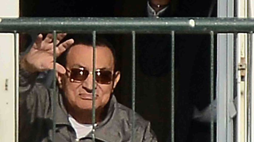Egypt's former president Hosni Mubarak waves to his supporters from the balcony of his room at the Maadi military hospital in Cairo on November 29, 2014 after a court dismissed a murder charge against the ousted leader over the deaths of protesters during a 2011 uprising that ended the former strongman's decades-long rule. The court also acquitted Mubarak of a corruption charge, but he will remain in prison because he is serving a three-year sentence in a separate corruption case. AFP PHOTO/AL-WATAN NEWSPAPER/MOHAMED NABILMOHAMED NABIL/AFP/Getty Images