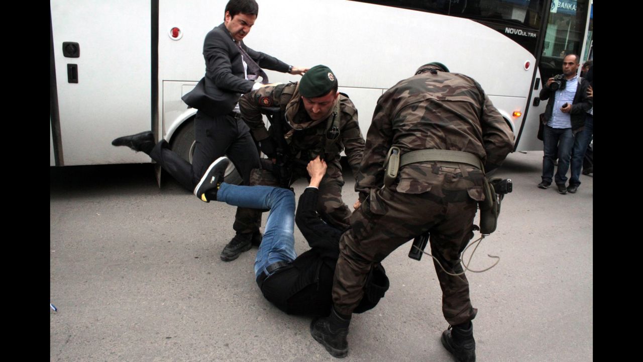 <strong>May 14:</strong> Yusuf Yerkel, an aide to Turkish Prime Minister Recep Tayyip Erdogan, kicks a person who is being wrestled to the ground by two police officers during protests in Soma, Turkey. <a href="http://www.cnn.com/2014/05/15/middleeast/gallery/turkey-mine-protests/index.html">Hundreds of protesters took to the streets</a> across Turkey following <a href="http://www.cnn.com/2014/05/13/europe/gallery/turkey-mine-accident/index.html">a deadly mine fire that occurred near Soma</a> on May 13.