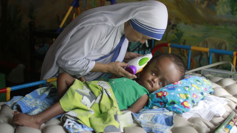 <strong>May 11:</strong> Sister Maricor from the Missionaries of Charity spends a moment with John, a 1-year-old with hydrocephalus, at an orphanage in Dhaka, Bangladesh. Hydrocephalus is characterized by an excessive accumulation of fluid in the brain.