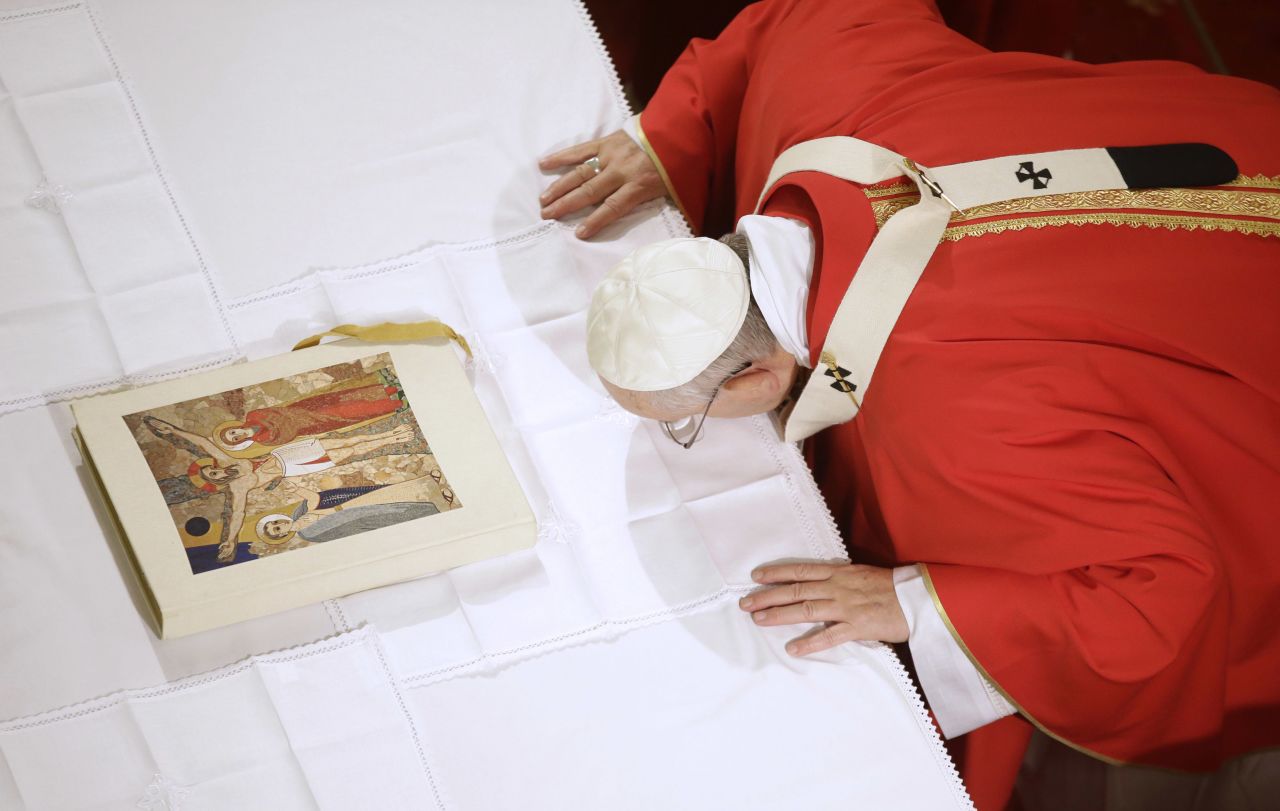 Pope Francis kisses the altar as he arrives to celebrate a Mass inside the Holy Spirit Cathedral in Istanbul on November 29.