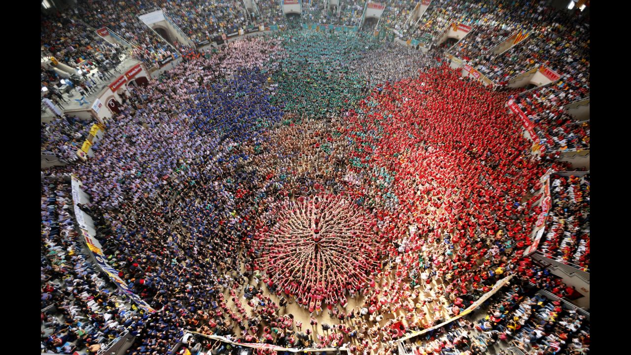 <strong>October 5:</strong> People form a human tower called a castell during a biannual competition in Tarragona, Spain. The formation of human towers is a tradition in Spain's Catalonia region.