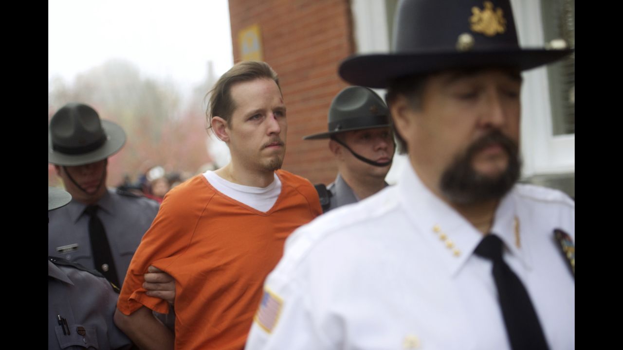 <strong>October 31:</strong> <a href="http://www.cnn.com/2014/09/22/justice/pennsylvania-suspected-cop-killer" target="_blank">Eric Matthew Frein</a> exits the Pike County Courthouse after his arraignment in Milford, Pennsylvania. Frein, who is accused of killing a Pennsylvania state trooper and wounding another, was found at an abandoned airport near Tannersville, Pennsylvania, authorities said. He had been on the run for nearly two months.