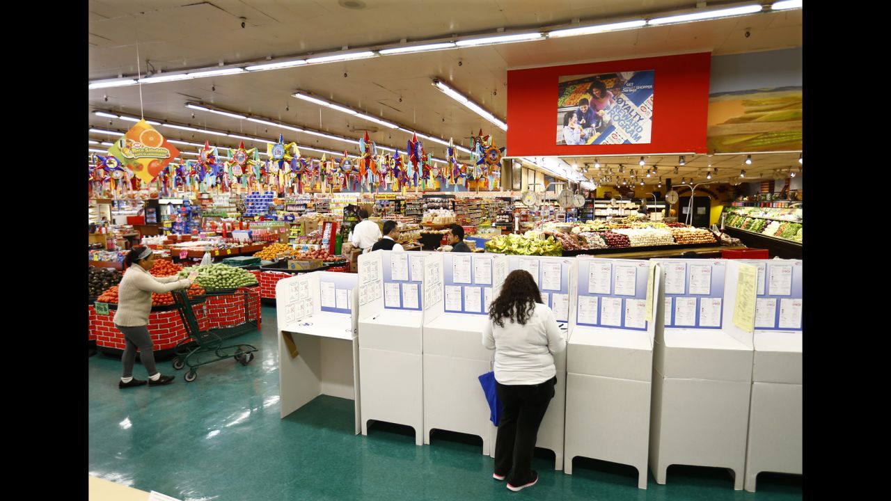 <strong>November 4:</strong> A woman in National City, California, votes inside a grocery store during U.S. midterm elections. <a href="http://www.cnn.com/2014/11/04/politics/gallery/america-votes/index.html">See more of the places America votes</a>