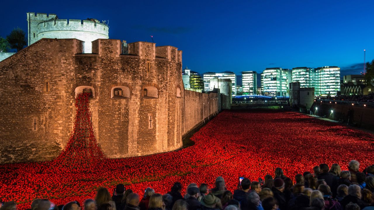 <strong>November 7:</strong> Visitors view <a href="http://www.cnn.com/2014/08/04/europe/gallery/tower-of-london-art-installation/index.html">the ceramic poppy installation</a> at the Tower of London. Thousands of ceramic poppies were installed in the dry moat surrounding the tower to mark the 100th anniversary of World War I. There were 888,246 poppies, one for each British military member that died during the war. The installation, called "Blood Swept Lands and Seas of Red," was created by artist Paul Cummins.