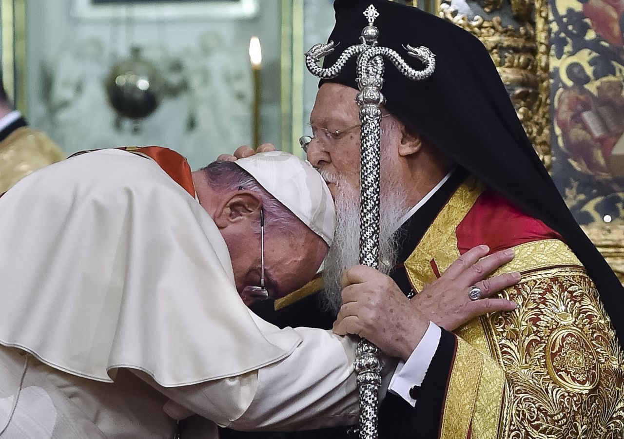 Ecumenical Patriarch Bartholomew I kisses the Pope during an ecumenical prayer at the Patriarchal Church of St. George in Istanbul on Saturday, November 29.