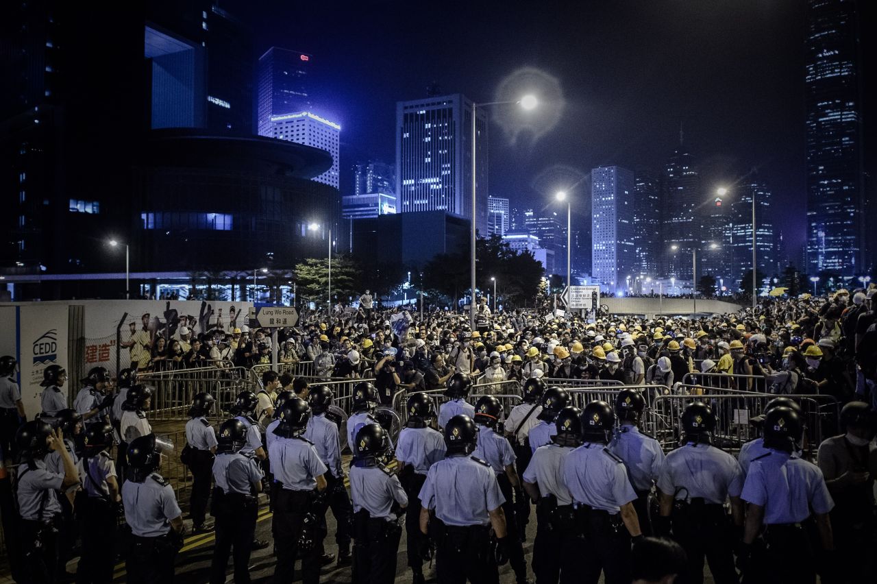 Pro-democracy protesters face police forces after clashes in the Admiralty district of Hong Kong on Sunday, November 30. 