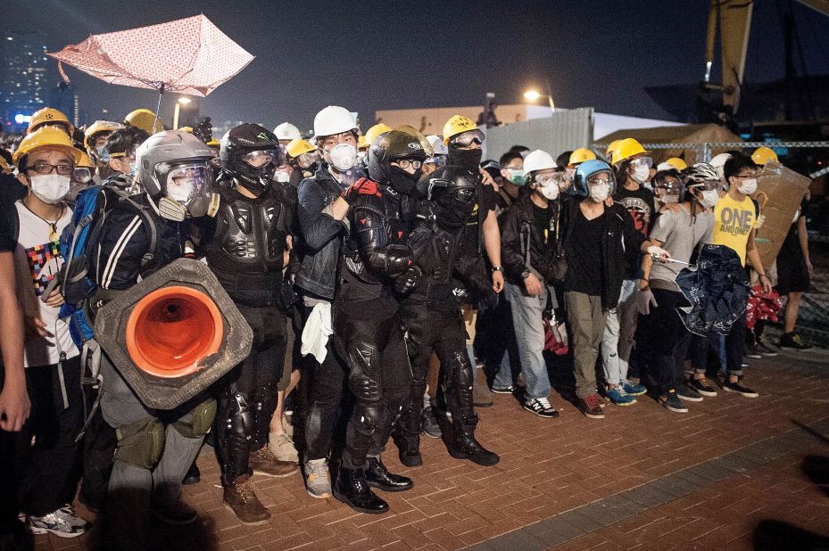 Pro-democracy protesters push police back as they advance on Lung Wo Road outside Hong Kong's Government complex on November 30.
