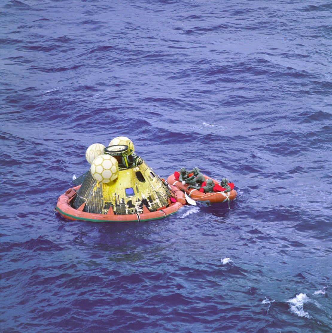Apollo 11 crew members Neil Armstrong, Michael Collins and Buzz Aldrin wait to be picked by a helicopter on July 24, 1969. The fourth man in the raft is a U.S. Navy swimmer.
