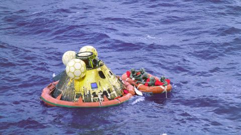 Apollo 11 crew members Neil Armstrong, Michael Collins and Buzz Aldrin wait to be picked by a helicopter on July 24, 1969. The fourth man in the raft is a U.S. Navy swimmer.