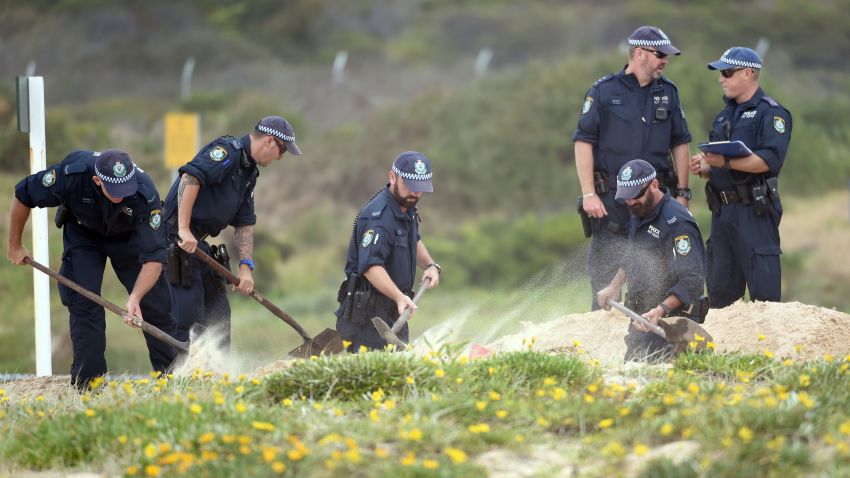 Police dig in the sand dunes after children playing at a Sydney beach on November 30, 2014, stumbled across the body of a baby buried under the sand, Australian investigators said, just a week after a newborn was found crying at the bottom of a roadside drain. New South Wales police said they had established a crime scene at the beach in the eastern Sydney suburb of Maroubra after the grisly discovery on Sunday morning. AFP PHOTO/William West (Photo credit should read WILLIAM WEST/AFP/Getty Images)