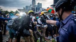 HONG KONG - DECEMBER 01: Pro-democracy protesters clash with police outside Hong Kong's Government complex on December 1, 2014 in Hong Kong. Leaders from the Federation of Students called on fellow protesters to attend a rally and come prepared for escalated action. Protesters were asked to bring masks, umbrellas and helmets in a bid to move the protests forward after police successfully cleared the Mong Kok protest site earlier this week. (Photo by Chris McGrath/Getty Images)