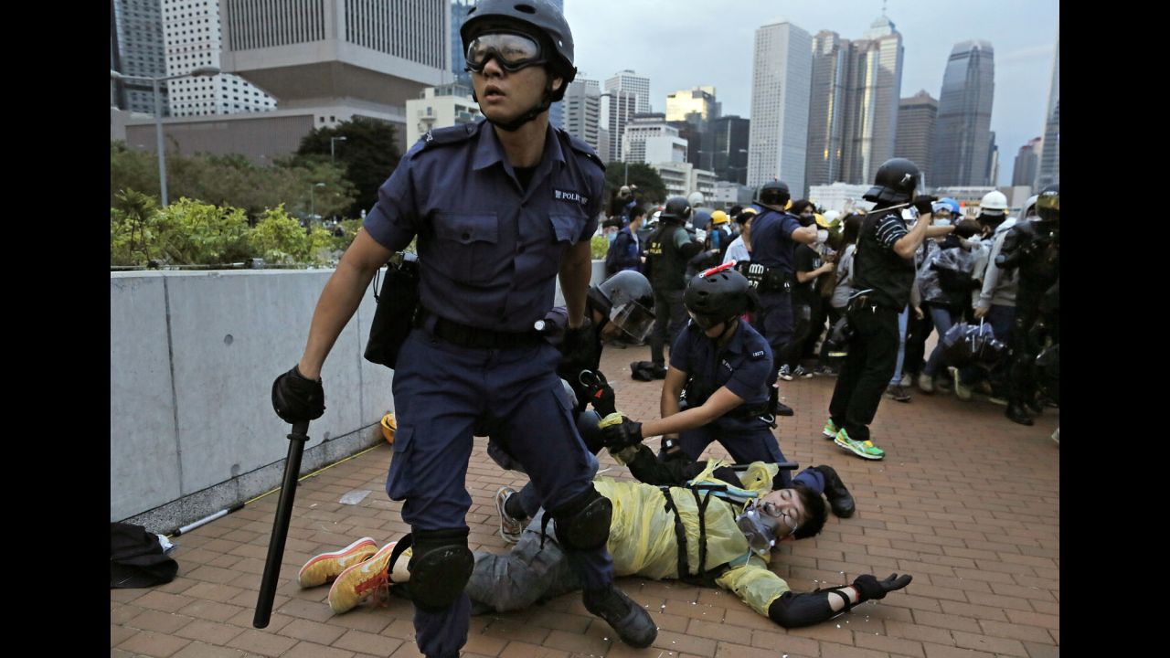 Police arrest a protester outside government headquarters in Hong Kong on December 1.