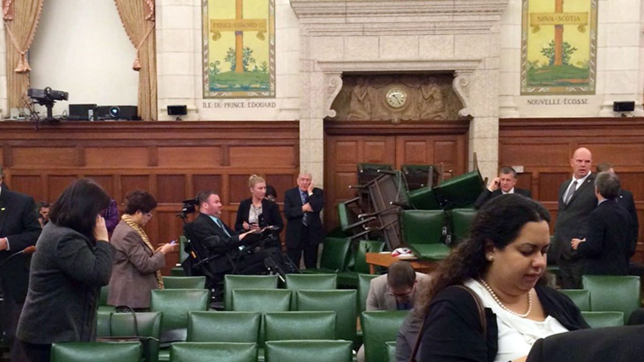 <strong>October 22:</strong> In this photo provided by Canadian politician Nina Grewal, members of Canada's Parliament barricade themselves in a meeting room after shots were fired on Parliament Hill in Ottawa. <a href="http://www.cnn.com/2014/10/22/world/gallery/canada-shooting-parliament/index.html">A Canadian soldier was fatally shot at the National War Memorial nearby,</a> police said, and the alleged gunman was killed.