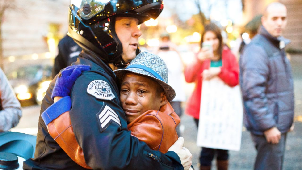 Devonte Hart, then 12, hugs Sgt. Bret Barnum at a rally in Portland, Oregon, in 2014.