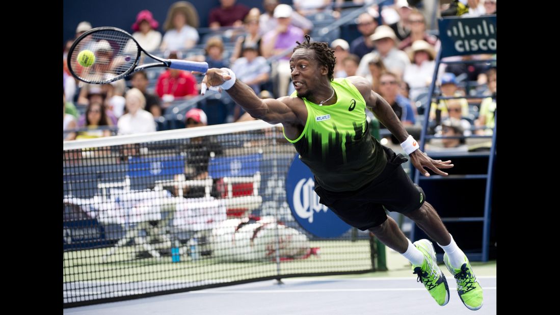 Gael Monfils loses his racket as he dives for the ball during his Rogers Cup match against Novak Djokovic on Wednesday, August 6, in Toronto. Djokovic won the second-round match in three sets.