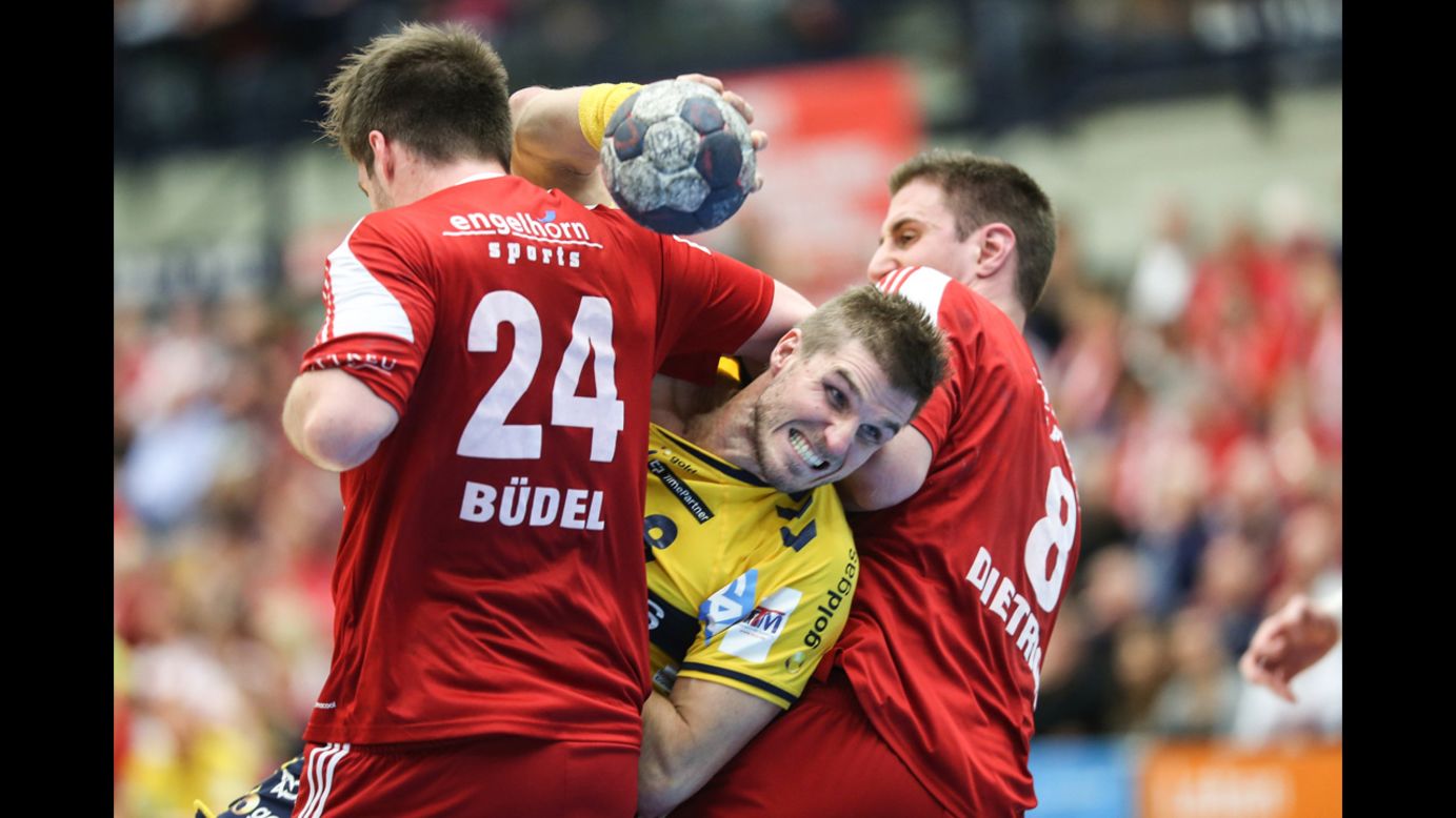 Bjarte Myrhol, a handball player with the German club Rhein-Neckar Lowen, is challenged by Nico Budel, left, and Gunnar Dietrich during a Bundesliga match Wednesday, November 26, in Ludwigshafen, Germany.