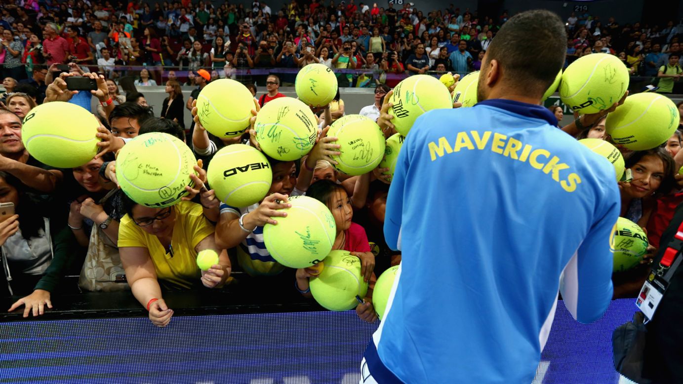 Jo-Wilfried Tsonga signs autographs for tennis fans in Manila, Philippines, on Sunday, November 30.