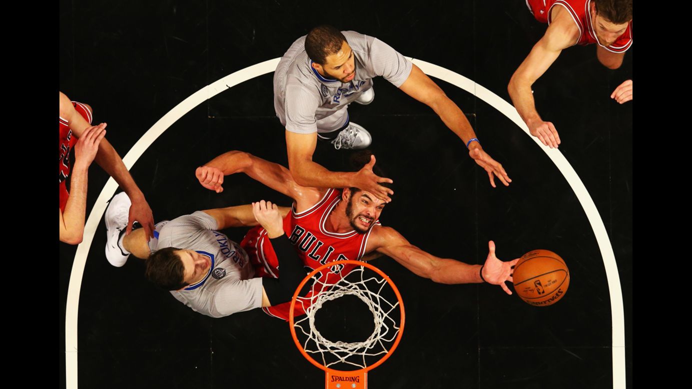 Joakim Noah of the Chicago Bulls reaches for a rebound while playing the Brooklyn Nets on Sunday, November 30.