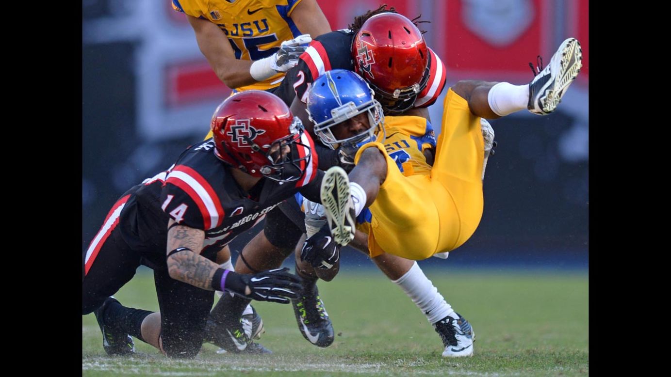 San Jose State wide receiver Tyler Ervin is tackled by two San Diego State defenders during San Diego State's 38-7 victory on Saturday, November 29.