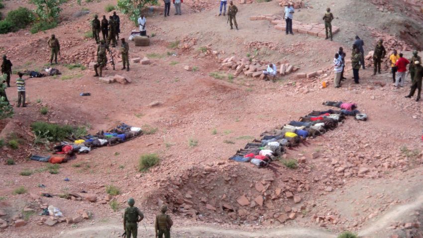 Soldiers of Kenyan Defence Forces look over the bodies of some  36 Kenyans  as they lie at a quarry, Tuesday, Dec. 2, 2014. Kenya police say that at least 36 quarry workers were killed in an attack in northern Kenya  by suspected Islamic extremists from Somalia. Kenyan police chief David Kimaiyo confirmed the workers were killed early Tuesday in Mandera County. (AP Photo) ,