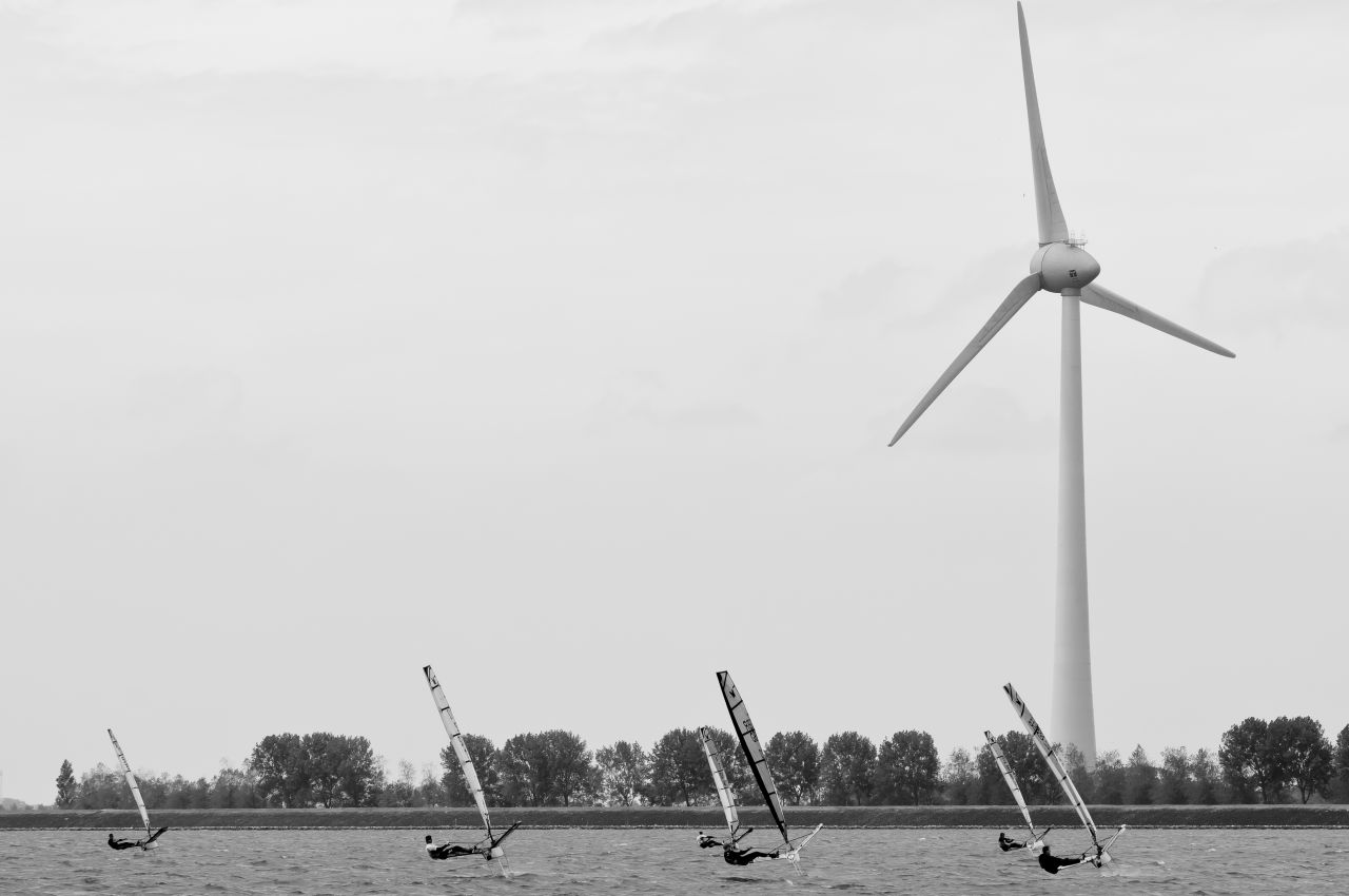 Tiny dinghy boats are elegantly captured against the backdrop of giant wind turbines during the EFG MothEuroCup in the Netherlands.<br />