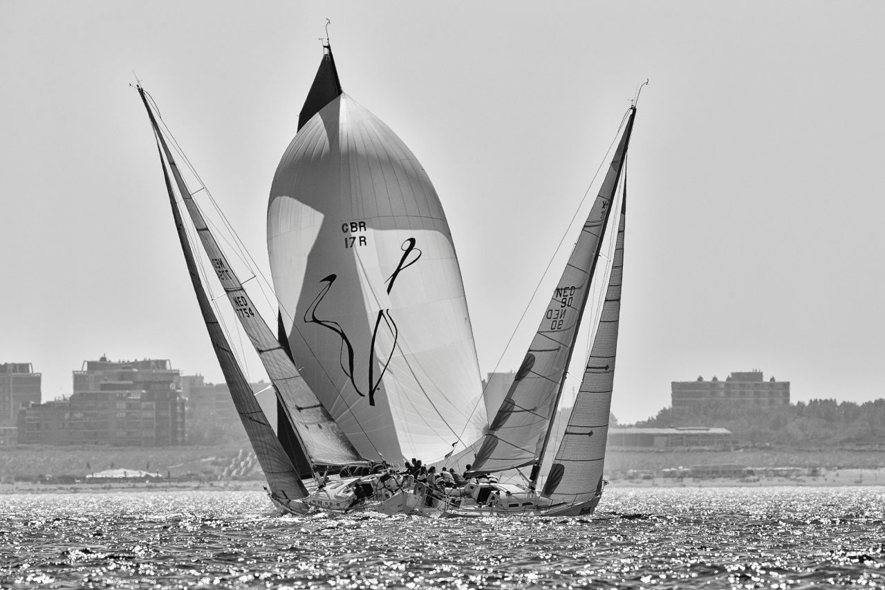 A pair of boats in the Delta Lloyd North Sea Regatta cross going upwind, creating a perfect gap for a competitor sailing downwind.