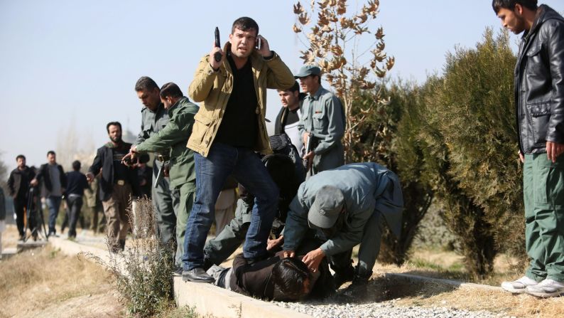 <strong>November 25:</strong> Afghan security personnel arrest a suspect after a bomb explosion in Kabul, Afghanistan.