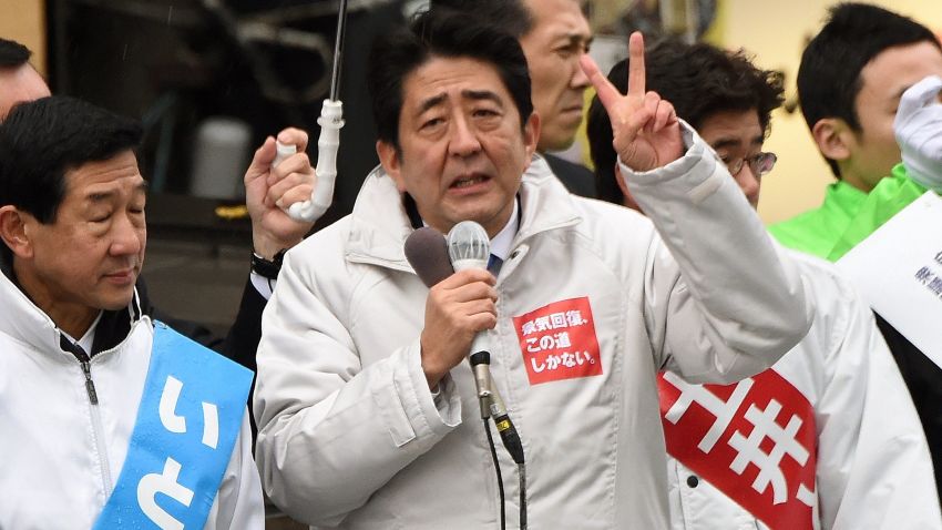 Surrounded by candidates of the ruling Liberal Democratic Party, Japanese Prime Minister Shinzo Abe (C) gestures as he delivers a speed during hisstumping tour for the December 14 general election in Sendai, Miyagi prefecture, on December 2, 2014. Official campaigning kicked off for a snap national poll in two weeks, with Prime Minister Abe describing it as a referendum on his faltering "Abenomics" economic growth blitz. AFP PHOTO/Toru YAMANAKATORU YAMANAKA/AFP/Getty Images