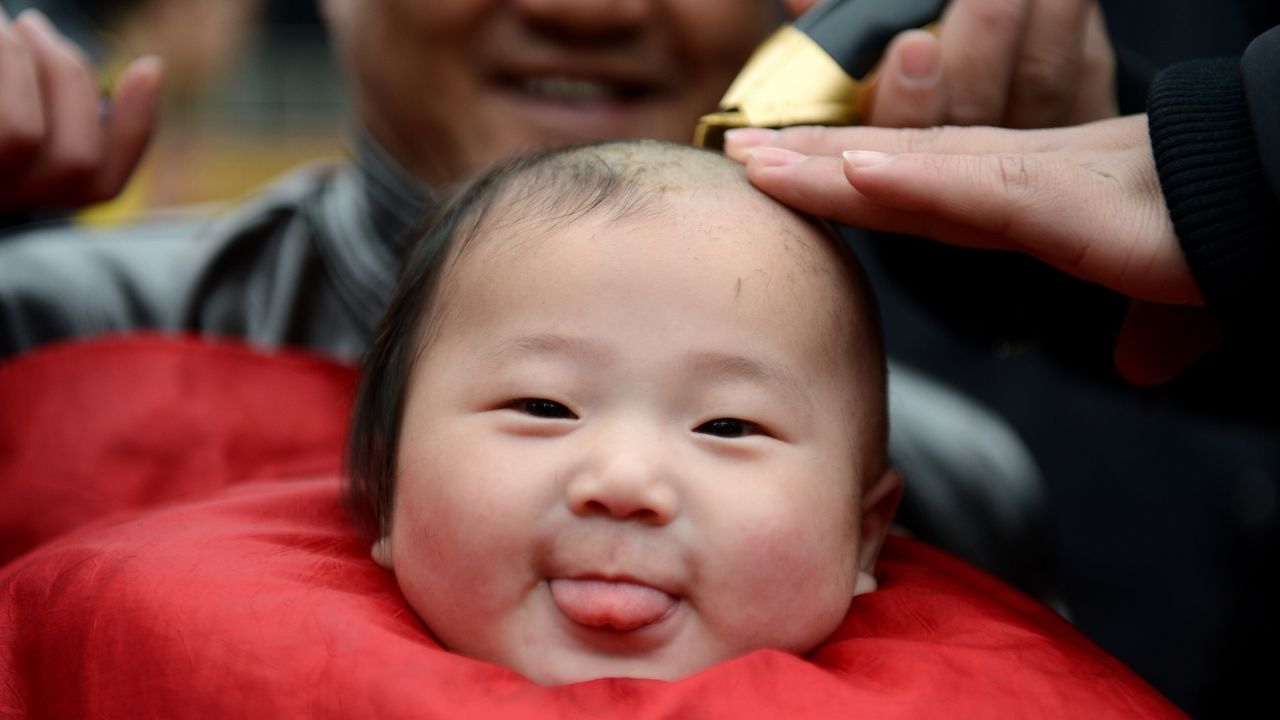 <strong>March 2:</strong> A baby has his hair cut in Hefei, China. Many in China believe it is good luck to have your hair cut on the second day of the second lunar month, known in Chinese as Er Yue Er, or "a time for the dragon to raise its head."