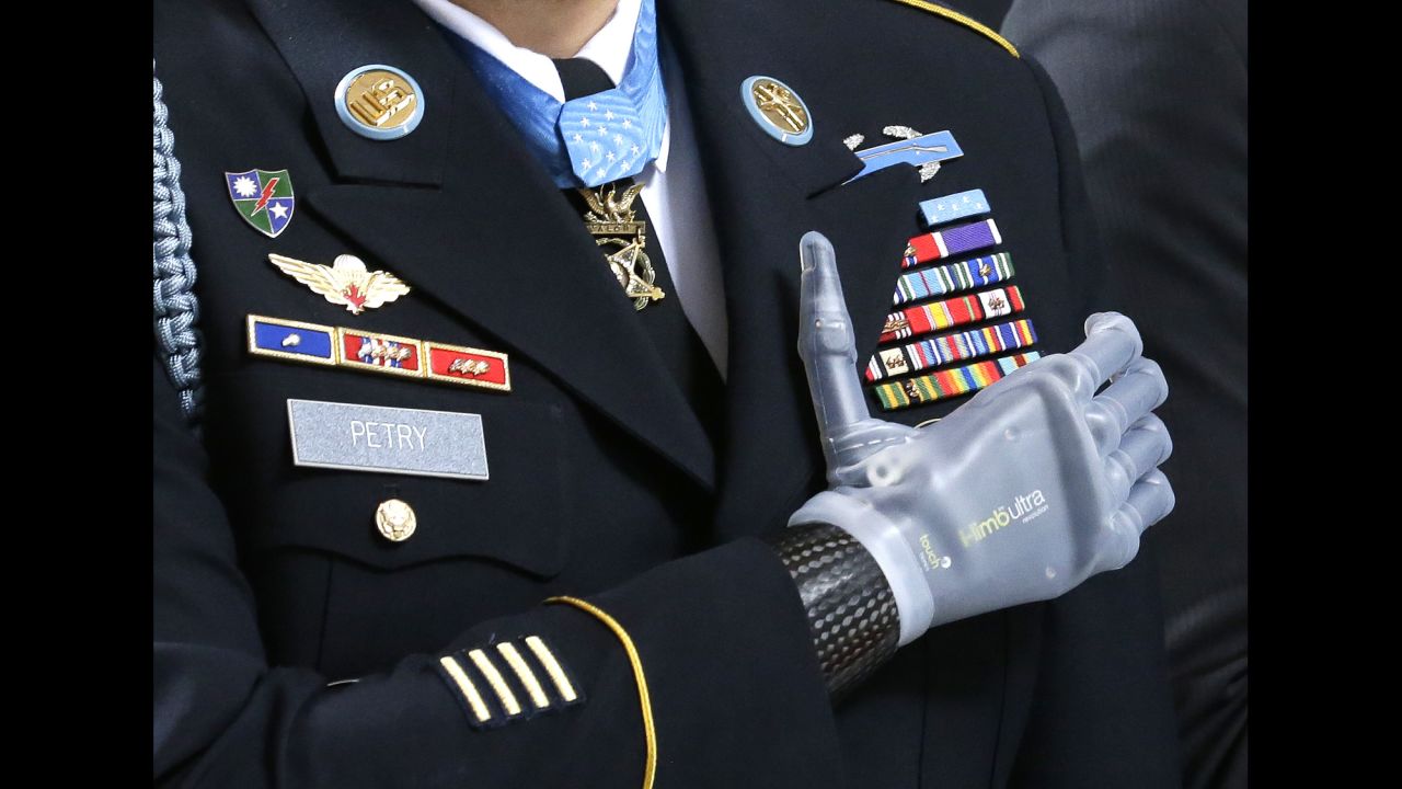 <strong>April 2:</strong> Sgt. 1st Class Leroy Petry stands during the Pledge of Allegiance at a ceremony held at the Capitol in Olympia, Washington. The ceremony honored Petry and other Medal of Honor recipients from Washington state. Petry lost his hand in 2008 when he was throwing an enemy grenade away from his fellow soldiers during combat in Afghanistan.