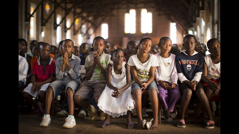 <strong>April 6:</strong> Children pray at a Catholic church in Kigali, Rwanda. Twenty years ago, <a href="http://cnnphotos.blogs.cnn.com/2014/04/03/like-being-in-the-valley-of-death/">mass killings began</a> in Rwanda. An estimated 800,000 civilians, mostly from the Tutsi ethnic group, were murdered over a period of about 100 days.