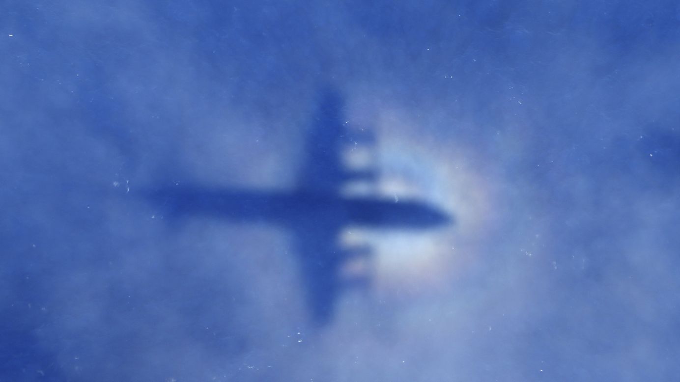 <strong>March 31:</strong> The shadow of a Royal New Zealand Air Force plane can be seen on low-level clouds as the plane flies over the southern Indian Ocean. Authorities combed thousands of square miles looking for Malaysia Airlines Flight 370, which disappeared March 8. Its whereabouts are still unknown.