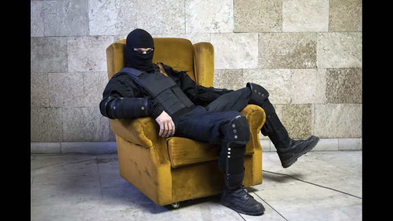 <strong>April 25:</strong> A pro-Russian rebel poses for a picture inside a regional government building in Donetsk, Ukraine, on Friday, April 25. <a href="http://www.cnn.com/2014/08/07/europe/gallery/ukraine-crisis/index.html">Fighting between Ukrainian troops and pro-Russian rebels in the country</a> has left more than 3,000 people dead since mid-April, according to the United Nations.