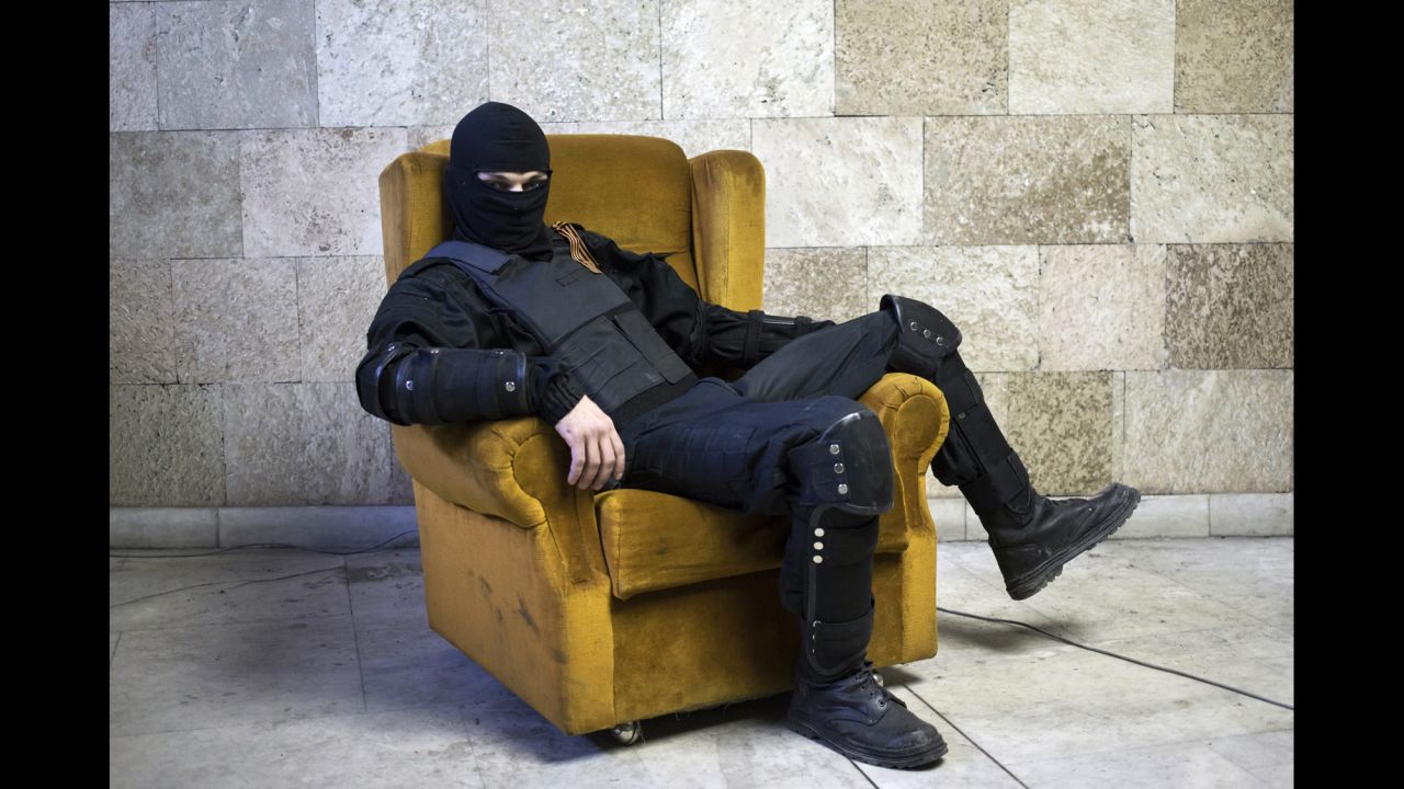 <strong>April 25:</strong> A pro-Russian rebel poses for a picture inside a regional government building in Donetsk, Ukraine, on Friday, April 25. <a href="http://www.cnn.com/2014/08/07/europe/gallery/ukraine-crisis/index.html">Fighting between Ukrainian troops and pro-Russian rebels in the country</a> has left more than 3,000 people dead since mid-April, according to the United Nations.