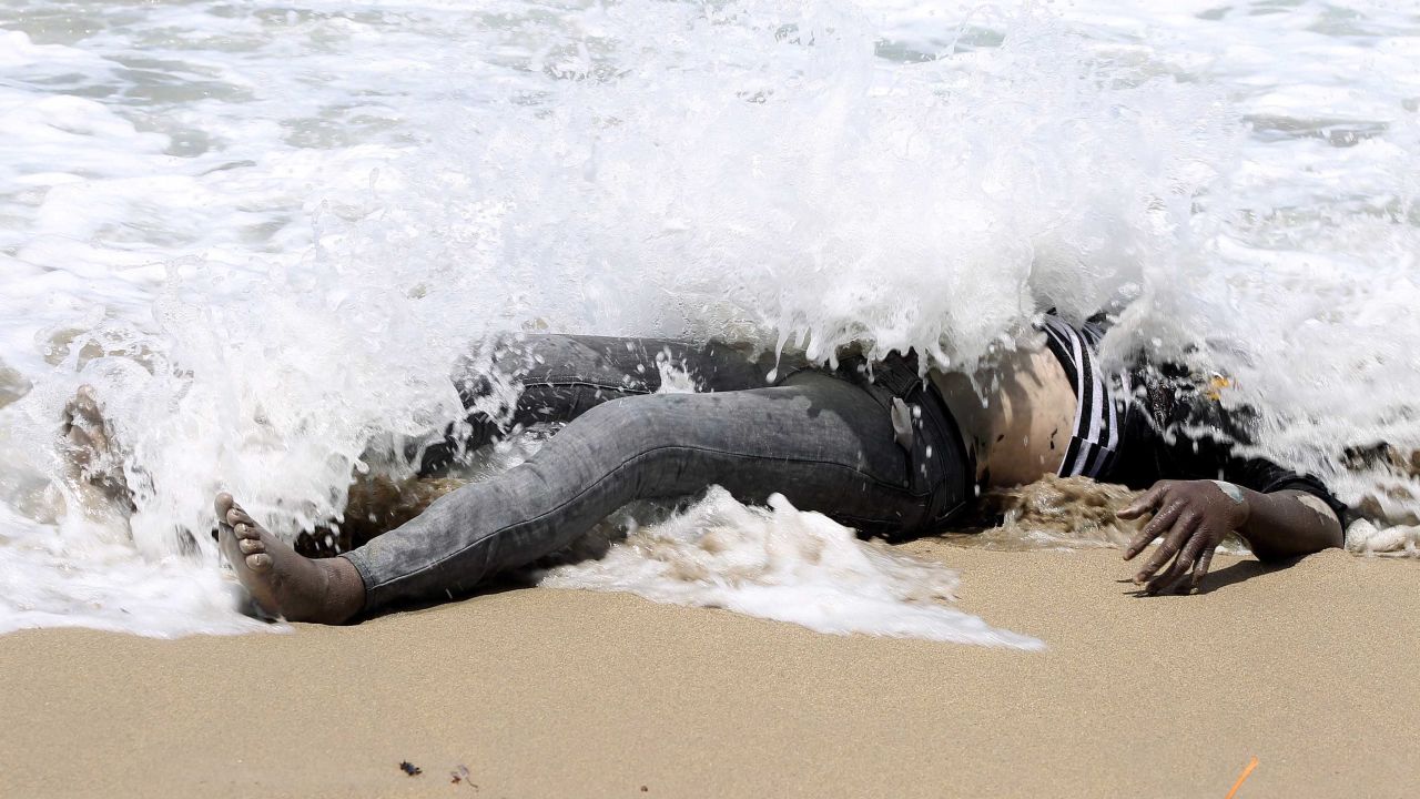 <strong>May 14:</strong> The body of an illegal migrant lies on the shore of al-Qarboli, Libya. Libyan officials said at least 40 people died and around 50 were rescued when <a href="http://www.cnn.com/2014/05/11/world/meast/libya-boat-migrants/index.html">a boat carrying mostly sub-Saharan migrants sank off the coast of Tripoli</a> on May 11.