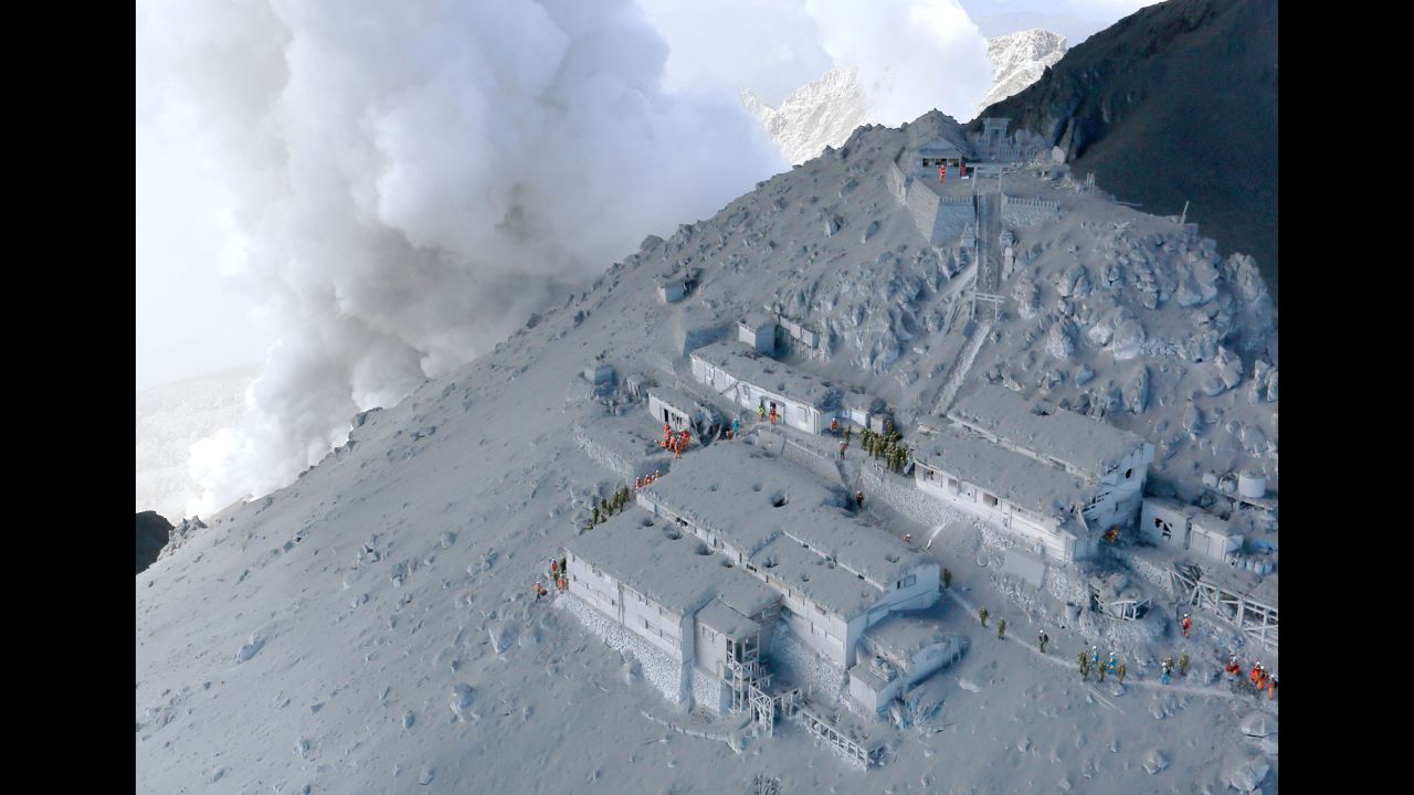 <strong>September 28:</strong> Firefighters and members of Japan's military conduct a rescue operation at a cabin near the peak of Mount Ontake. Dozens of people were killed <a href="http://www.cnn.com/2014/09/27/world/gallery/mount-ontake-erupts/index.html">when the volcano erupted</a>.