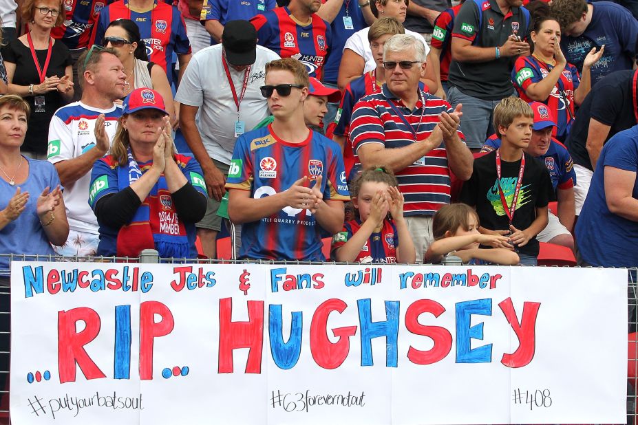 Newcastle fans applaud in memory of Phil Hughes at the 63 minute mark during the an A-League soccer match between the Newcastle Jets and Central Coast Mariners on November 30 in Newcastle, Australia. Hughes' was injured while on 63 not out, charging the number with symbolism for mourners.