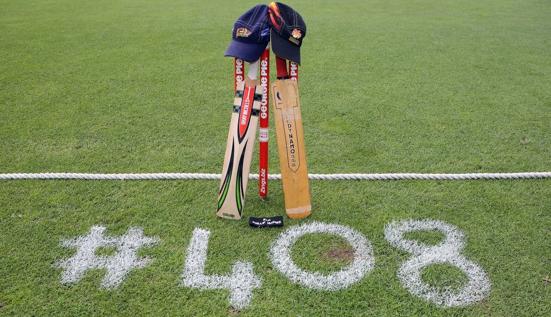 New Zealand cricket teams the Otago Volts and Wellington Firebirds place a bat, cap and black armband on the University Oval in Dunedin in memory of Australian cricketer Phil Hughes. Hughes was the 408th player to play Test cricket for Australia when he made his debut in 2009.