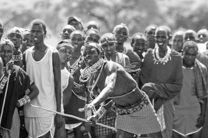 A Maasai tribesman throws a rungu club at a target as part of the rungu throwing event.