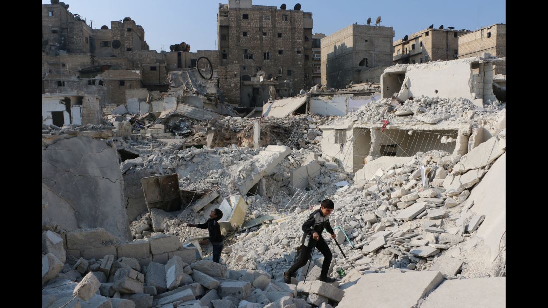 Syrian boys play in the ruins of a destroyed building in Aleppo on Tuesday, November 18.