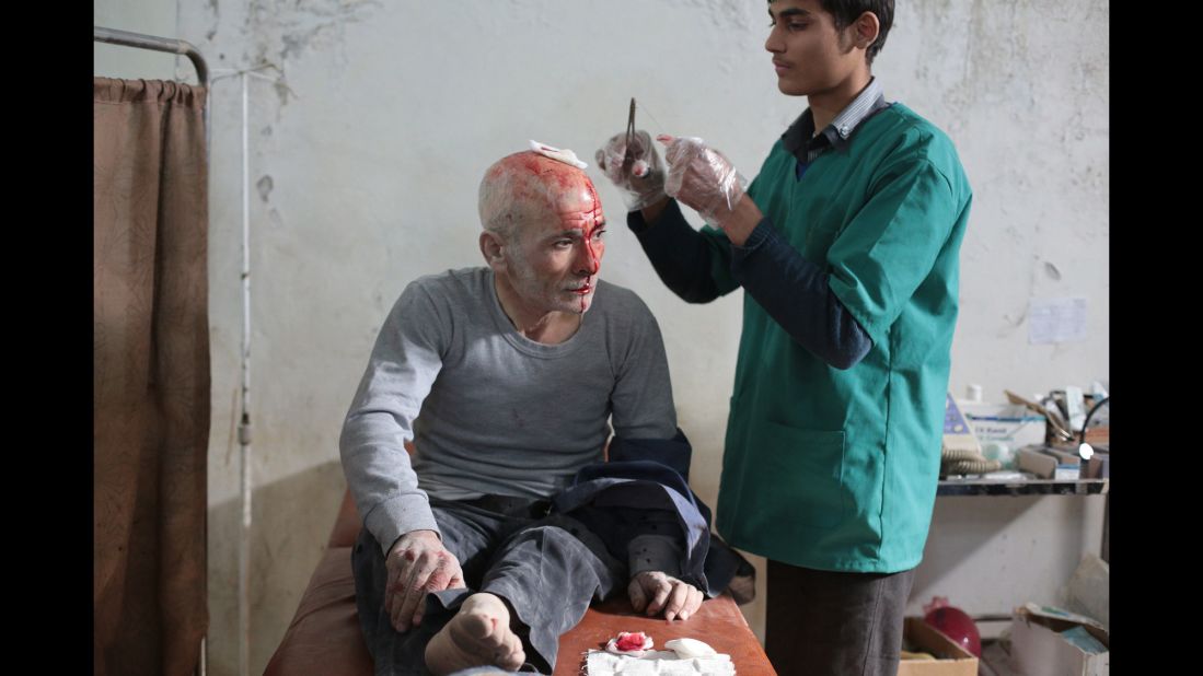 A wounded man is treated at a makeshift hospital in Damascus, Syria, following a reported air strike by government forces on Tuesday, November 11.