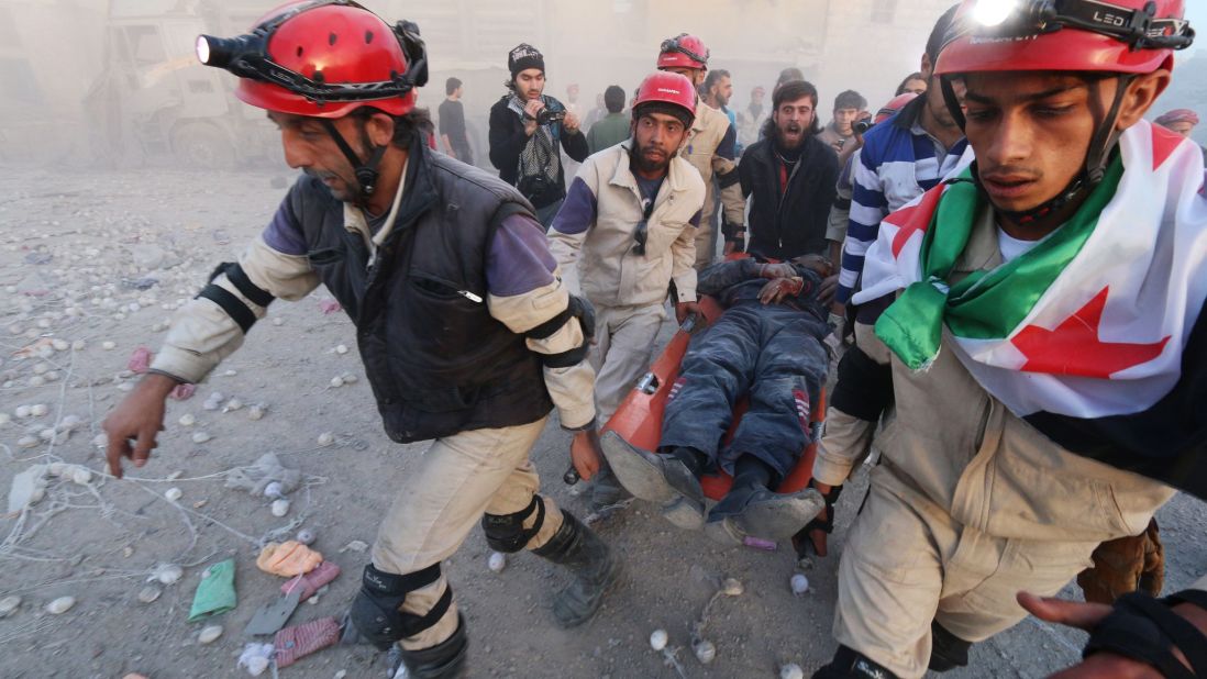 Members of the Syrian Civil Defense carry an injured man after an alleged air strike in Aleppo on November 11.